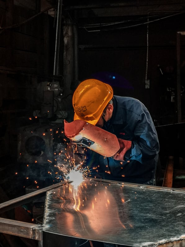 Man Welding on Gray Metal Sheet